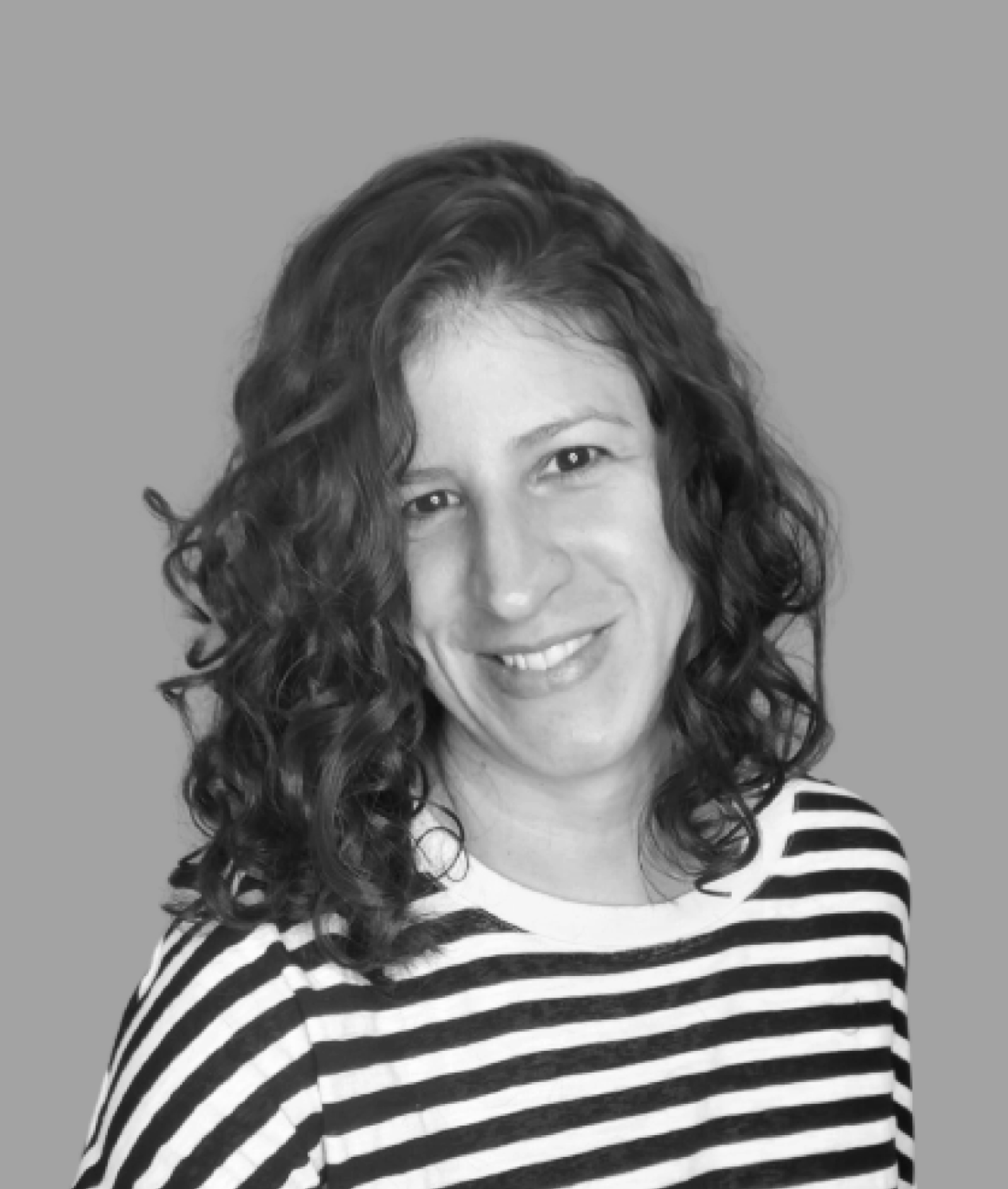 Portrait of Raquel Vilas, Product Designer, smiling in a black and white photo.